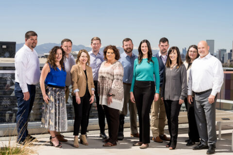 Healthcare Revenue Cycle Consulting team standing in pose of collaboration and teamwork